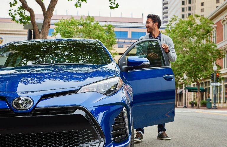 Man entering 2019 Toyota Corolla from driver side door