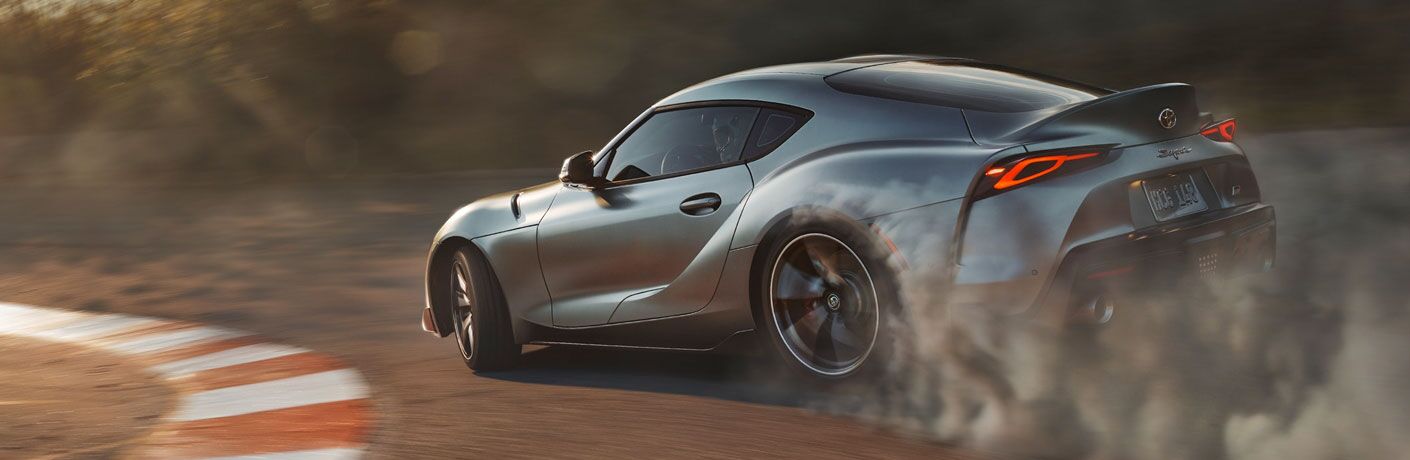 Silver 2020 Toyota Supra driving around turn on track
