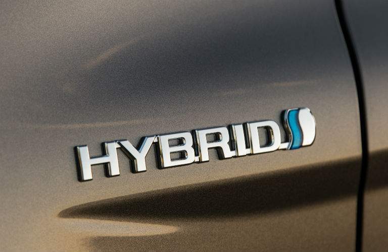 A close up photo of the Hybrid badge found on the 2018 Camry Hybrid