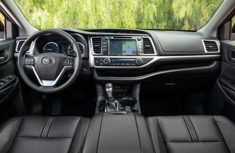 An interior view of the dashboard, infotainment system and center gauge cluster of the 2018 Toyota Highlander