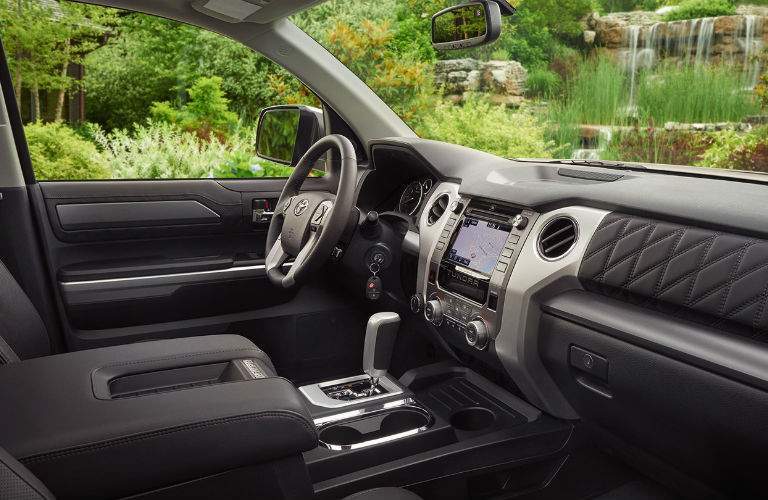 A photo from the passenger side of the 2018 Toyota Tundra showing its interior elements and infotainment system interface