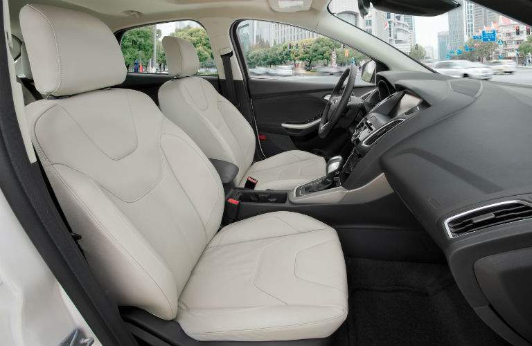 A view of the front of the 2018 Ford Focus from the passenger side with a white interior