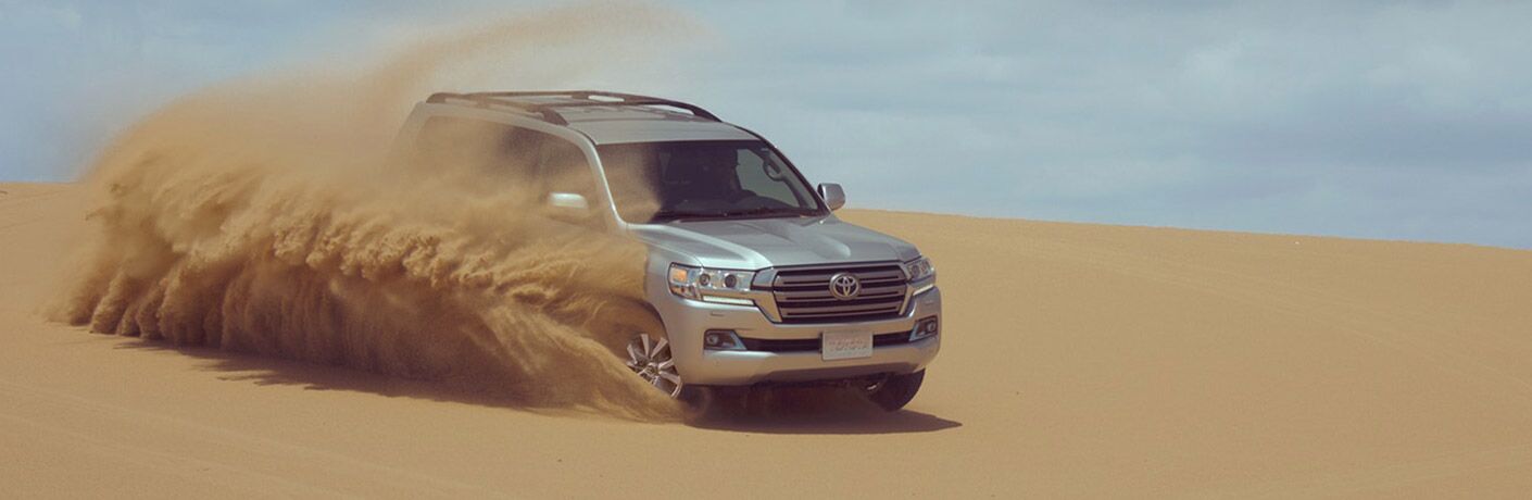 2018 Toyota Land Cruiser driving on sand.