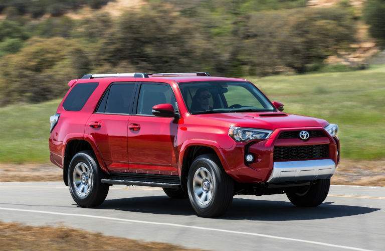 A front right profile view of a red 2018 Toyota 4Runner in motion on the road