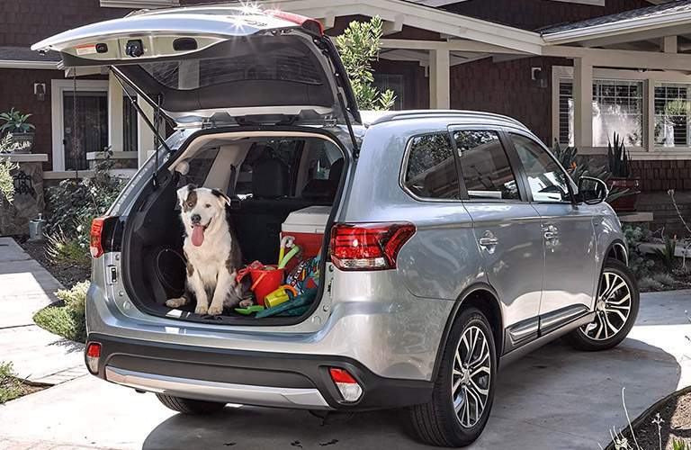 2017 Mitsubishi Outlander exterior liftgate open and packed with a dog inside