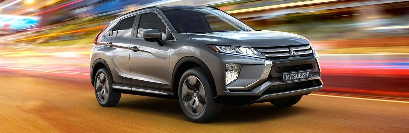 2020 Mitsubishi Eclipse Cross transcends time and space as it drives through a multicolored void.