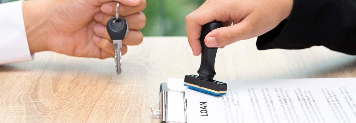 loan being approved and car keys handed to new owner