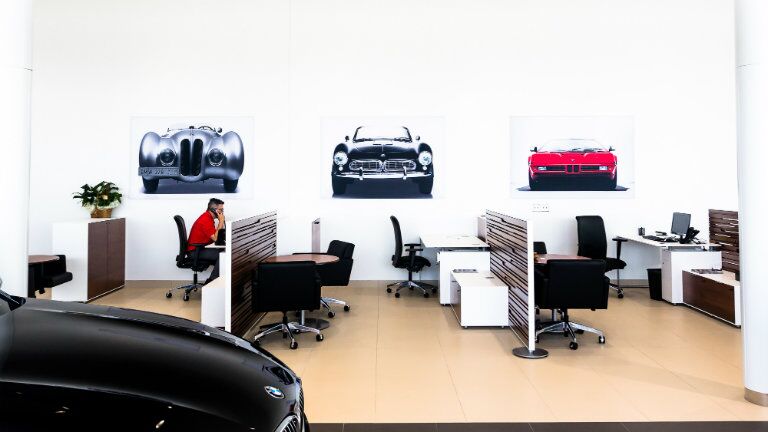 showroom area of the New BMW and Volkswagen of Topeka with customer service cubicles