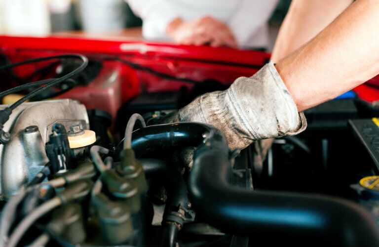 technician working in a car's engine