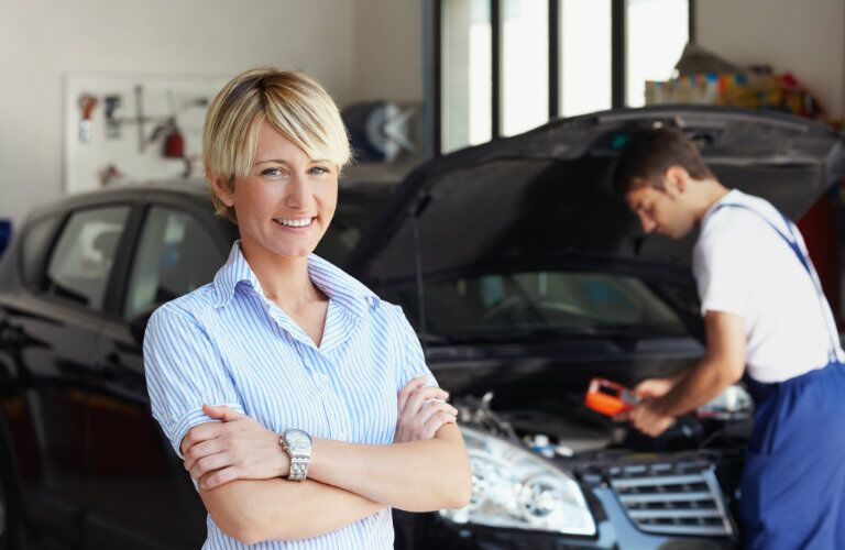 happy woman getting car repairs
