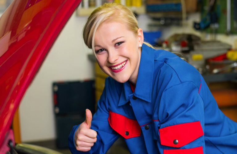 happy female service technician giving the thumbs up