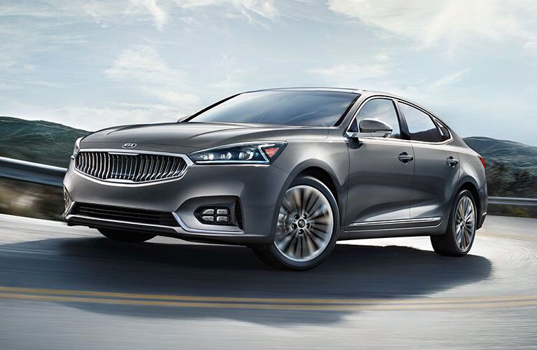 Gray Kia Cadenza driving