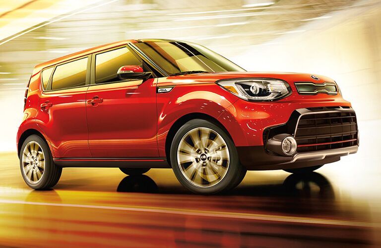 red Kia Soul driving