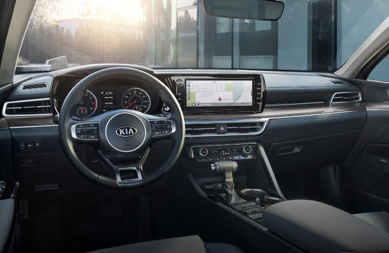 2021 Kia K5 midsize sedan interior shot of front seating, steering wheel, transmission, and dashboard layout