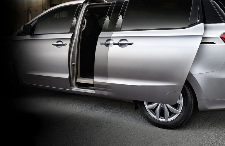 2021 Kia Sedona minivan exterior shot of smart sliding rear doors in action