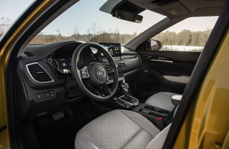 2021 Kia Seltos interior shot of front seating, steering wheel, and dashboard