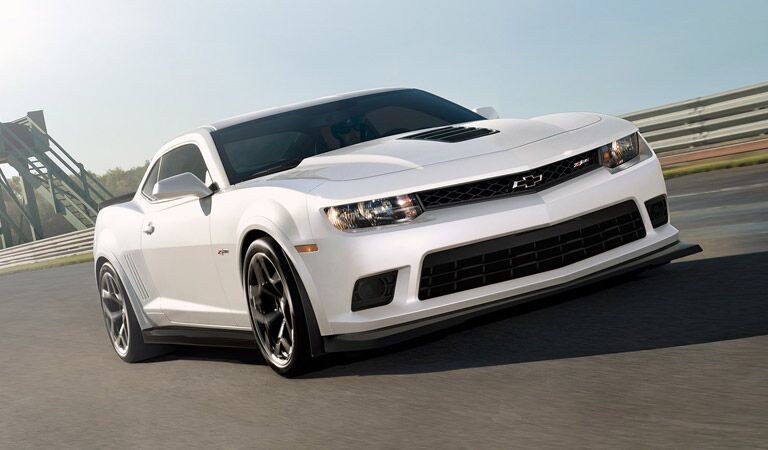 White Chevy Camaro on a bridge