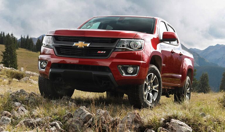 Red Chevy Colorado by mountains