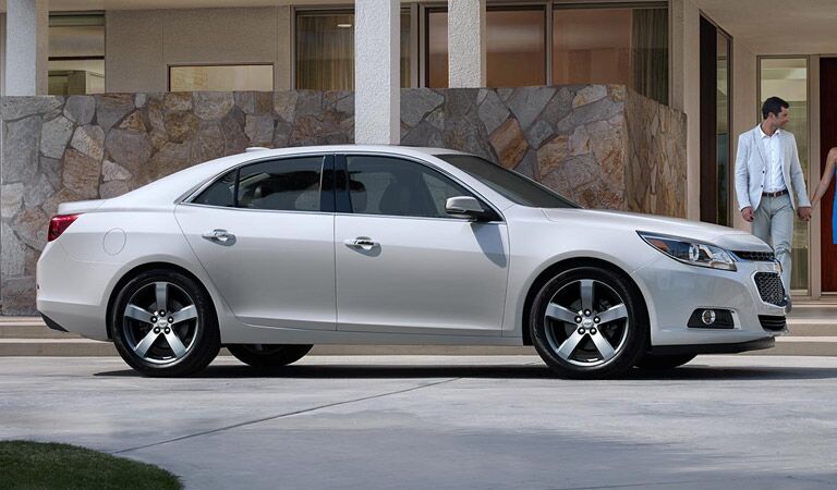 White Chevy Malibu waiting outside a hotel