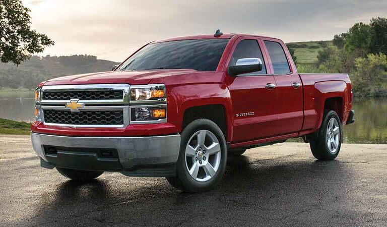 Red Chevy Silverado 1500 among fields