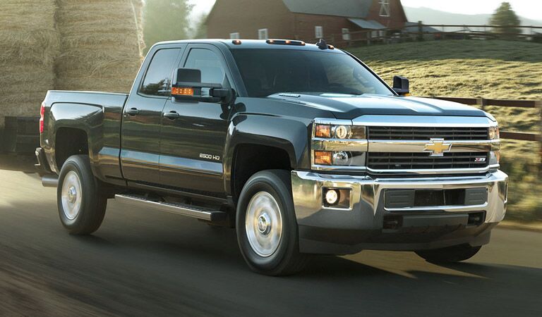 Black Chevy Silverado 2500HD by the farm