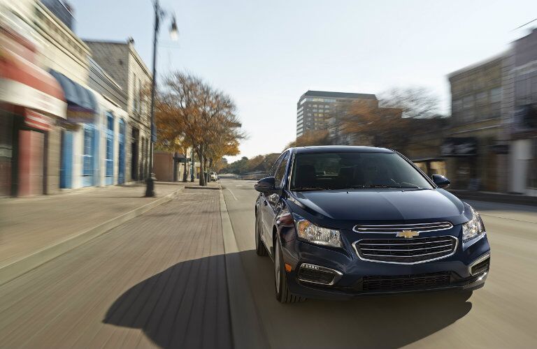 2015 Chevy Cruze driving down a city street
