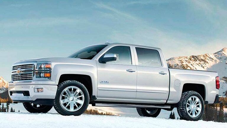 white 2015 Chevy Silverado on a snowy background