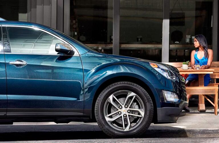 The front of a blue 2017 Chevy Equinox in the street winnipeg, mb