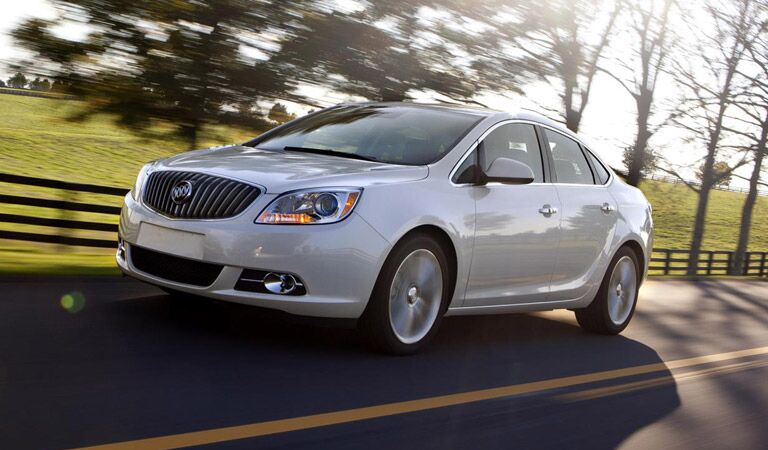 White Buick Verano driving in the country