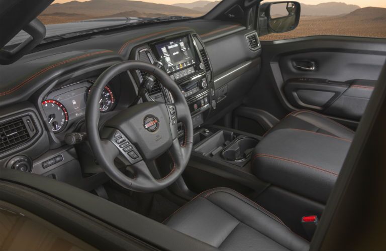 A photo of the driver's cockpit and dashboard in the 2021 Nissan Titan.