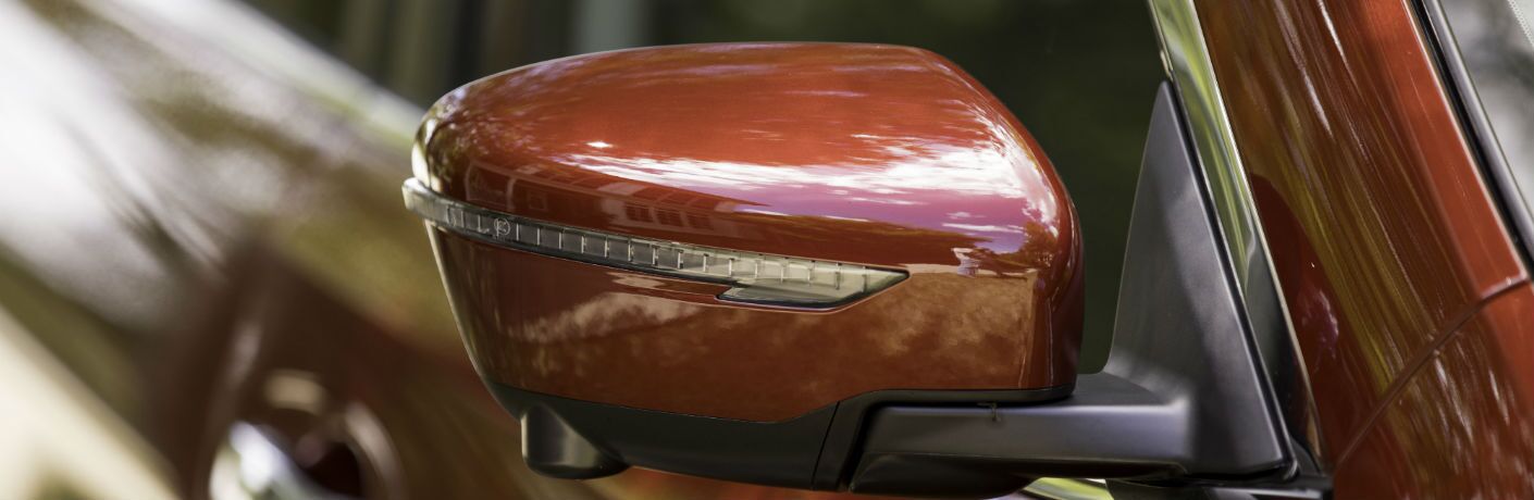 A photo of the heated side mirror with integrated turn signal on the 2019 Rogue.