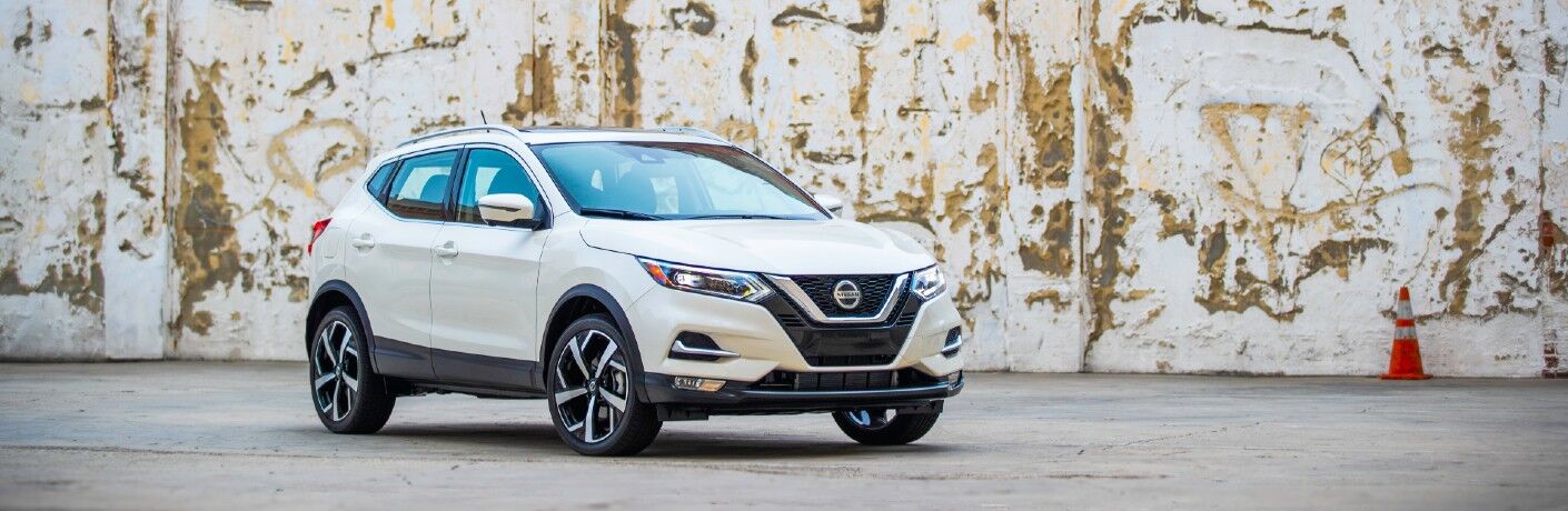 A 2021 Nissan Rogue Sport parked by a wall.