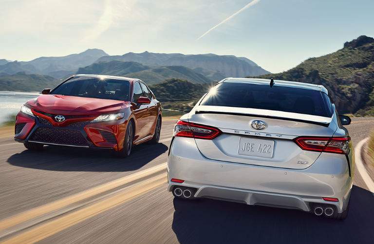 Red and Silver 2018 Toyota Camry Models on Curved Mountain Road