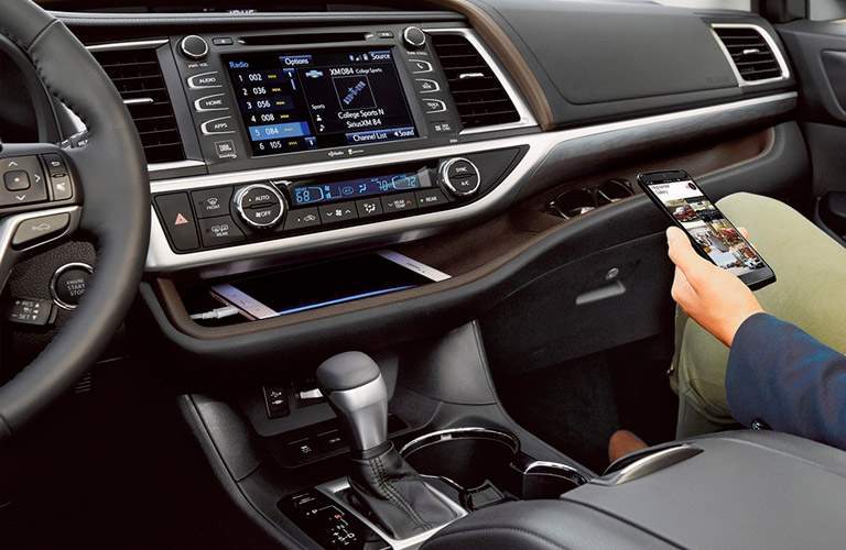 2018 Toyota Highlander Hybrid In Bloomington Person Holding A Phone In The Front Seat Of 2018 Toyota Highlander Hybrid By