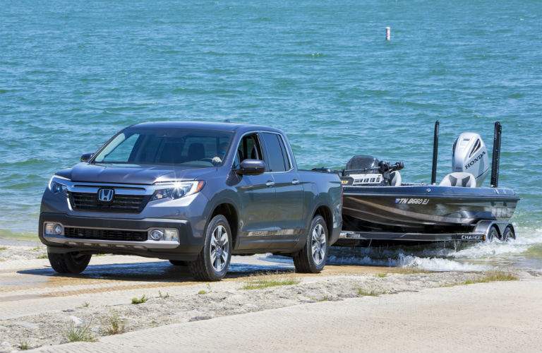 A photo of a 2018 Honda Ridgeline pulling a boat out of the water