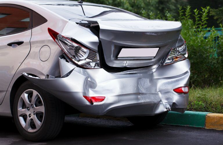 Silver car with smashed bumper