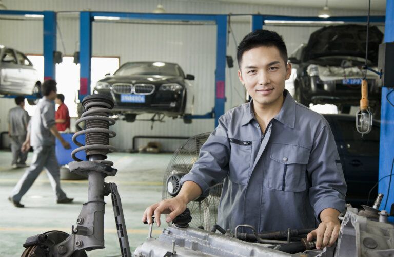 Mechanic smiling at camera