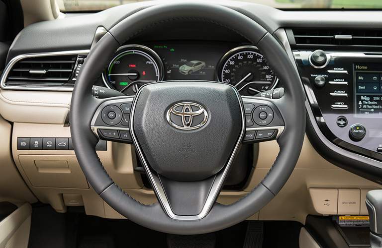 Steering wheel an driver info center of the 2018 Toyota Camry Hybrid