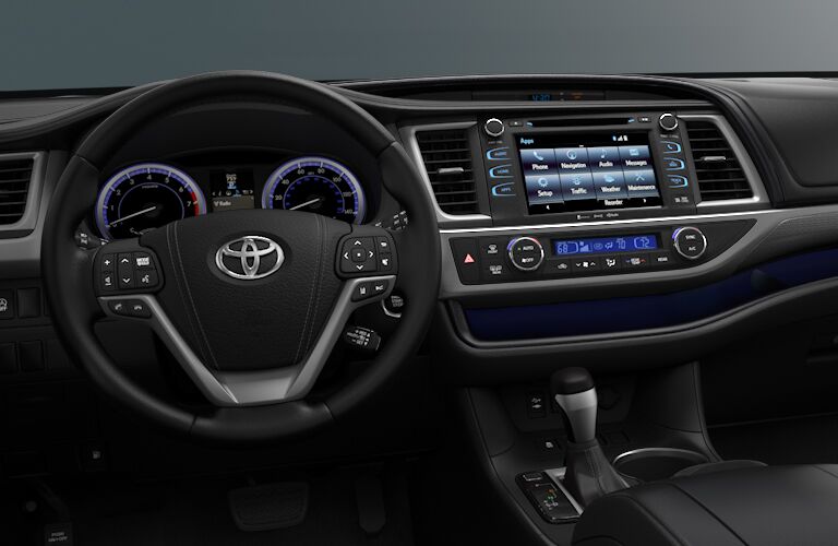 front interior of 2018 toyota highlander including steering wheel and infotainment sytem