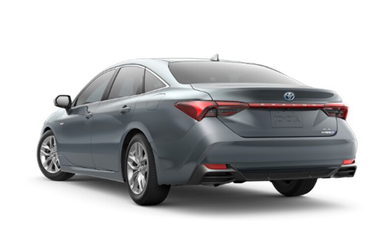rear and side view of silver 2019 toyota avalon hybrid against white background