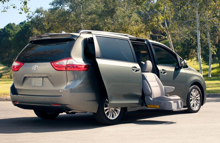 rear and side view of 2019 toyota sienna with cargo doors open and handicap accessible chair
