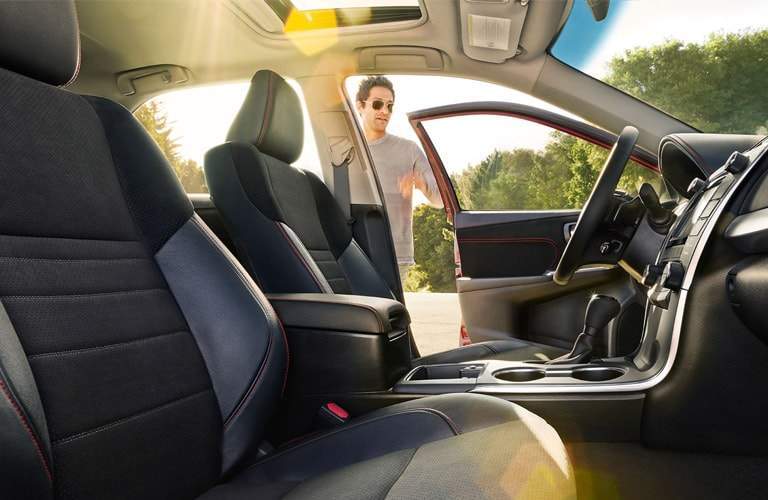 Man oping driver door of 2017 Toyota Camry