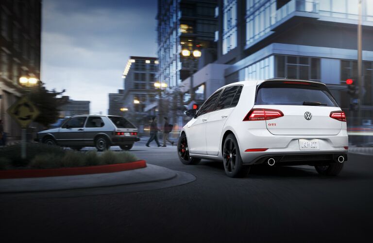 White 2019 Volkswagen Golf GTI driving on a roundabout