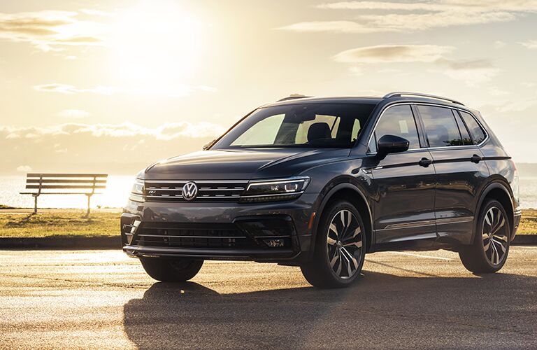 Dark grey 2020 Volkswagen Tiguan with the sun setting in the background