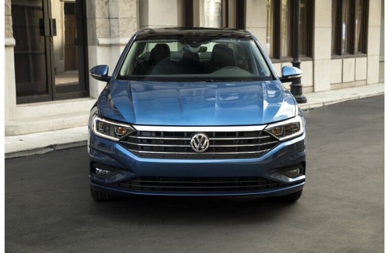 2019 Volkswagen Jetta exterior front shot of grille, headlights, bumper, and fascia parked in front of marble building
