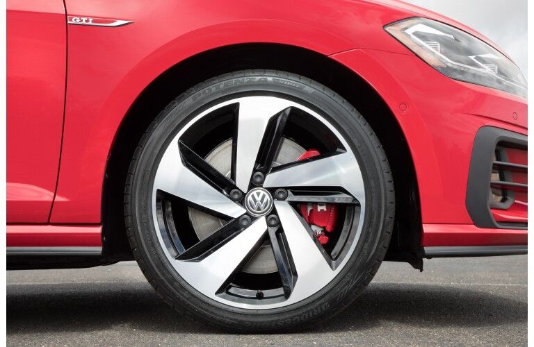 exterior side shot of 2018 Volkswagen Golf GTI wheelbase and tire design with red paint color body