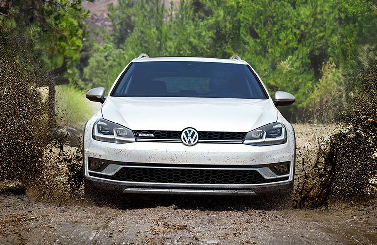White 2019 Volkswagen Golf Alltrack on a muddy trail