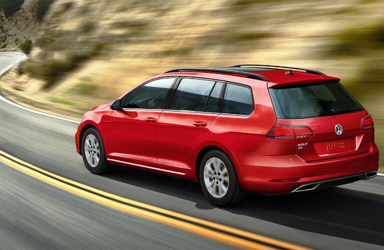 Red 2019 Volkswagen Golf SportWagen on a rural highway