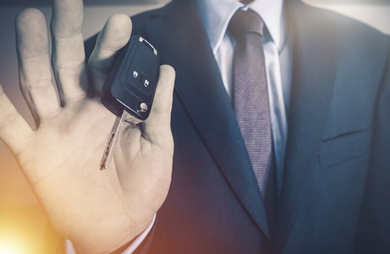 car dealer giving car keys to driver