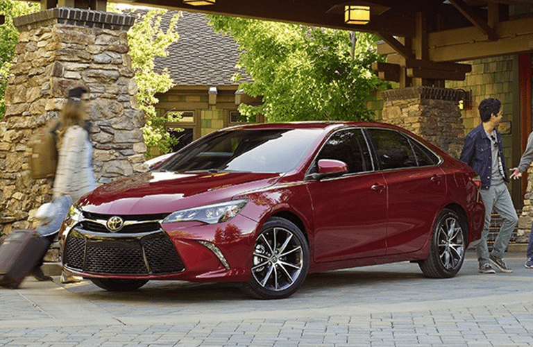 Toyota Camry in Red Parked Under Archway